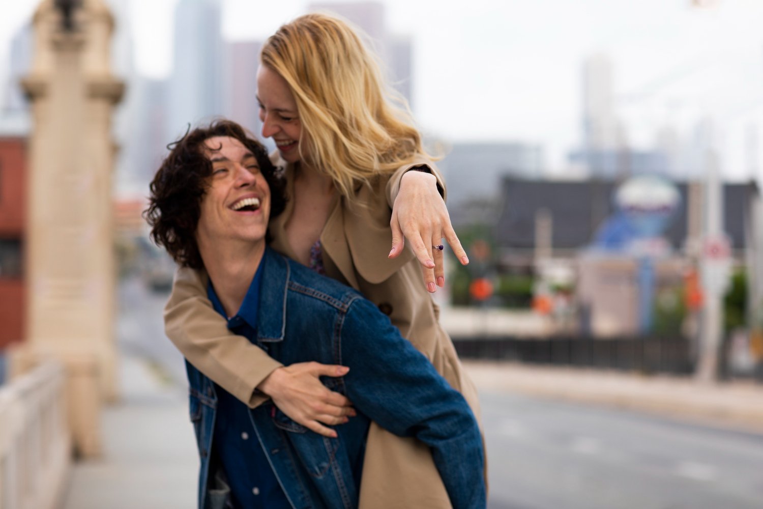 A couple laughing together against a New York city backdrop